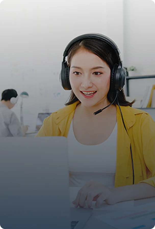 woman wearing headphones focused on her laptop